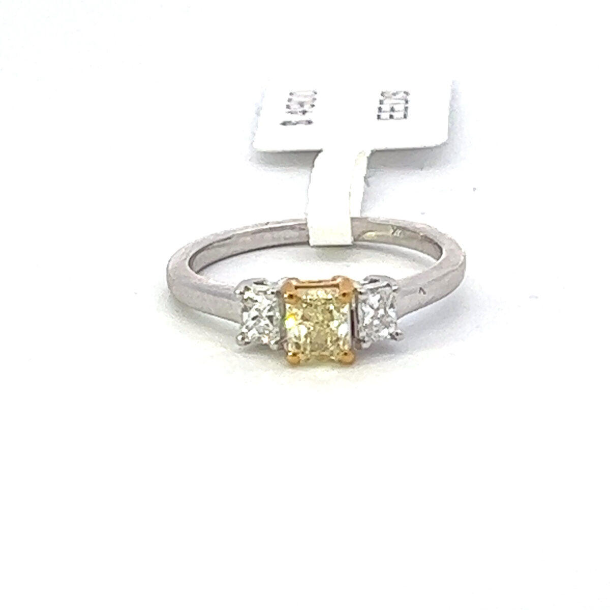 Three Stone ring with Natural Yellow Radiant cut center diamond with one white radiant cut diamond 14 kt yellow and white gold .94 ct tw