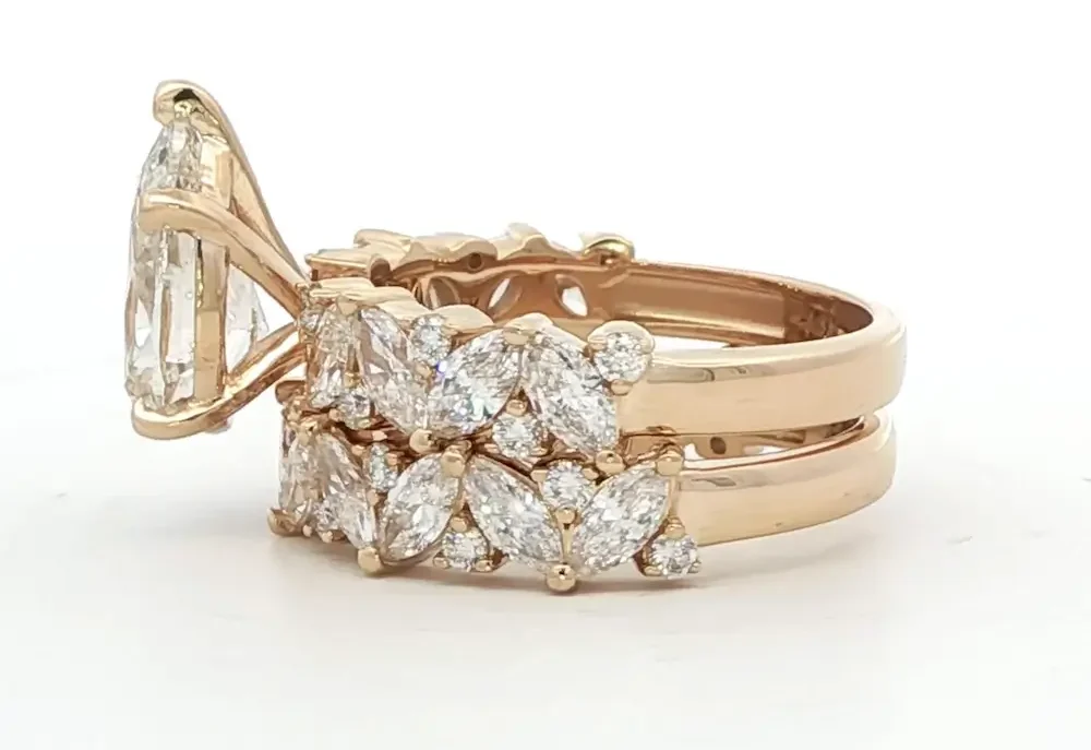 left view of custom pear-cut diamond multistone ring in rose gold from Elliott's Jewelers